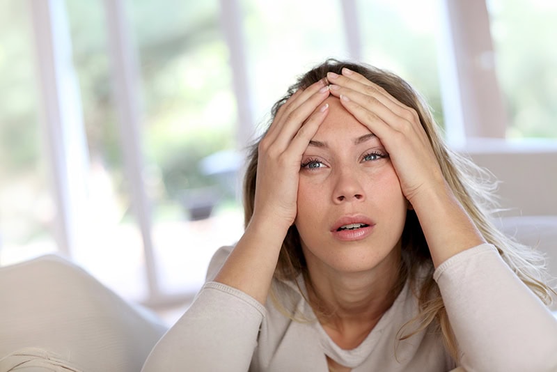 tired woman holding head
